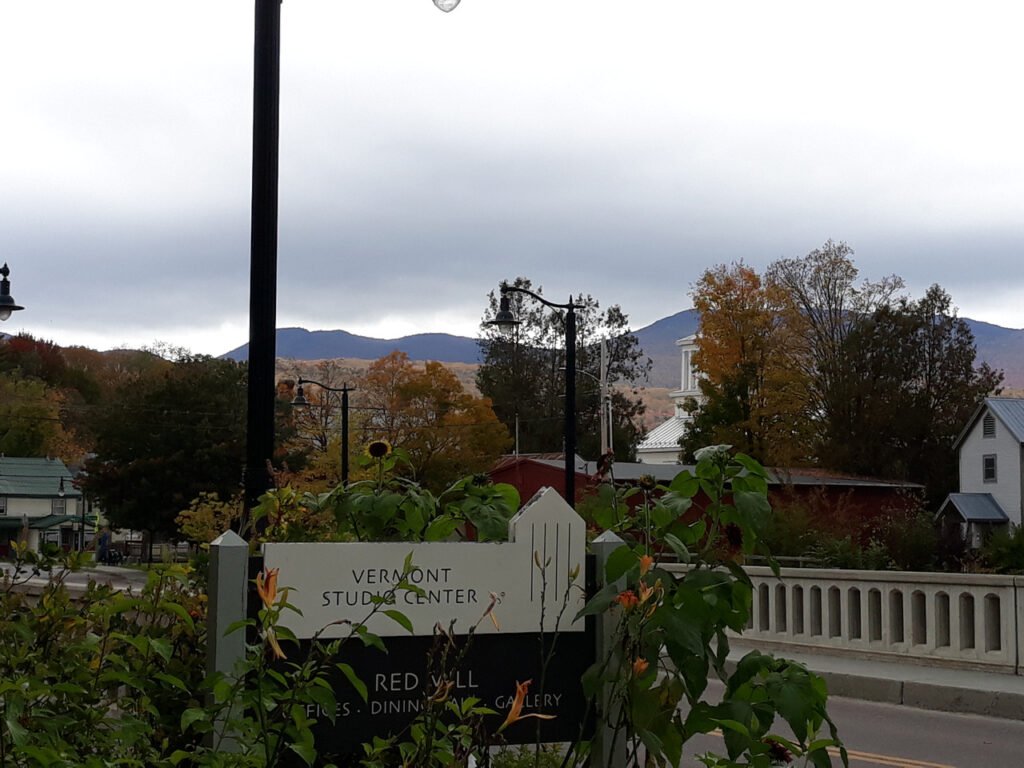 A street light with an attached sign, serving as a marker for navigation in the urban environment.