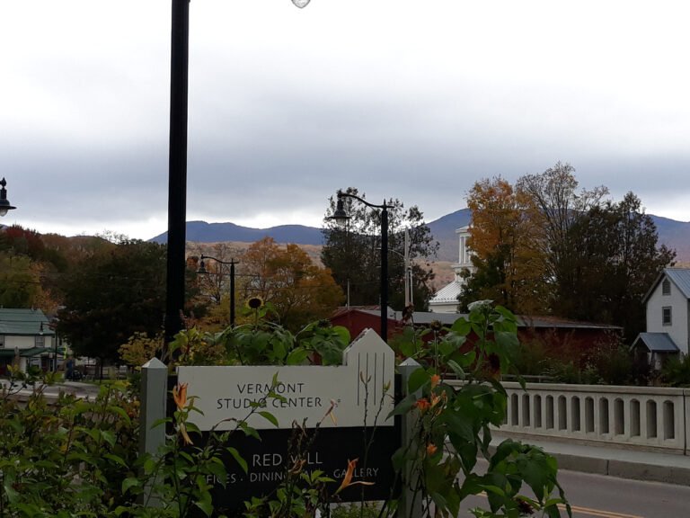 A street light with an attached sign, serving as a marker for navigation in the urban environment.