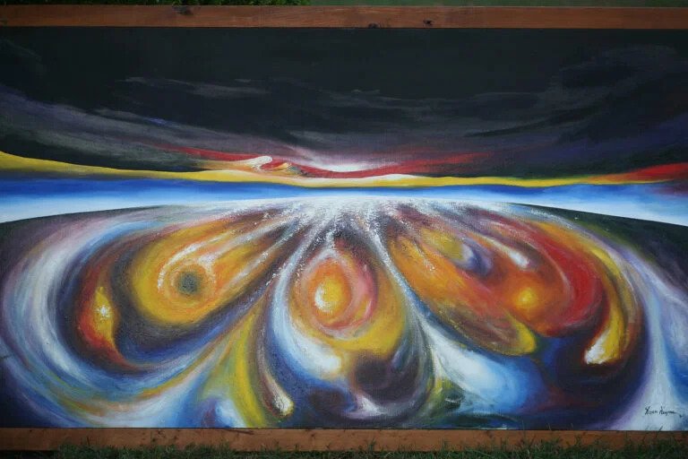 A colorful abstract painting on a blackboard, highlighting various hues and shapes in an expressive design.