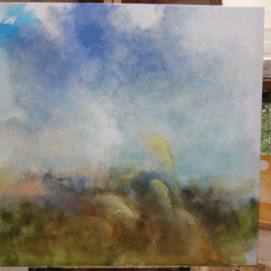 A painting of a serene landscape displayed on an easel, showcasing vibrant colors and natural scenery.