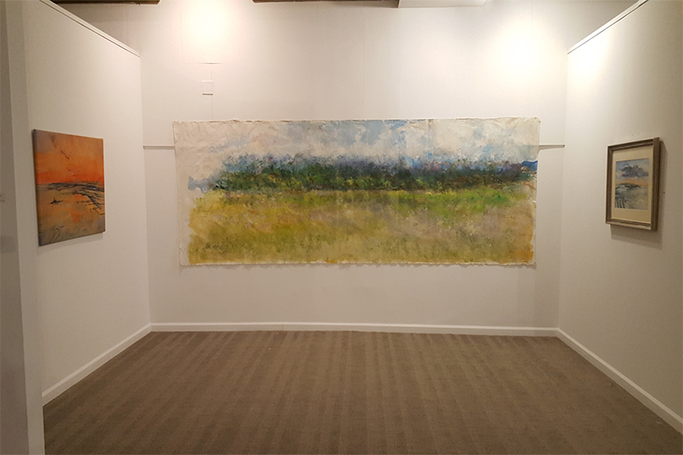 A painting is showcased on the wall of an art gallery, surrounded by soft lighting and minimalist decor.